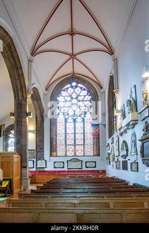St. Peter Port, Guernsey, Channel Islands - September 16, 2019: Altar with stained glass panel depicting various biblical figures inside the Town Chur Stock Photo