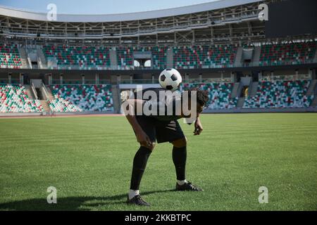 one football player is training holding the ball with his back Stock Photo