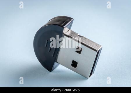 Mini bluetooth usb adapter on blue background close-up Stock Photo