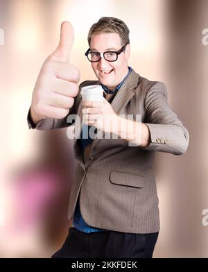 Funny boss giving big thumbs up approval with disposable coffee cup inside corporate cafeteria. Good coffee Stock Photo