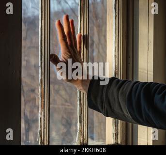 White man hand on old fashion window copy space background image, draped concept, mental health Stock Photo
