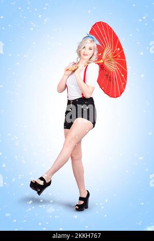 Beauty portrait of joyful smiling young woman model holding umbrella while kicking the blues with feet up under summer rain Stock Photo