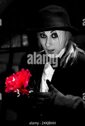 A Magician Pulls A Red Flower Out Of Her Sleeve In A Romantic Gesture Showing Love Is A Magic Trick Stock Photo