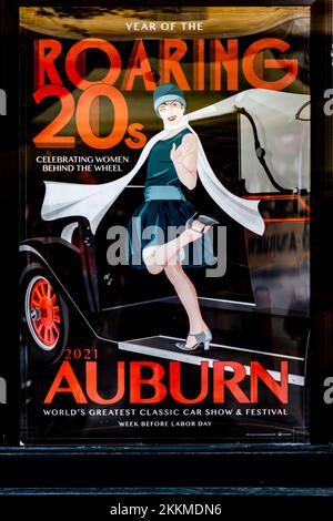 The 2021 Auburn Cord Duesenberg Festival poster featuring a flapper. Stock Photo