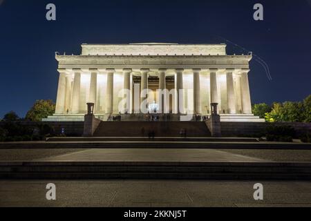 Tourists visit the Lincoln Memorial in Washington, D.C. on an autumn night. Long exposure wide shot from the east side of the building. Stock Photo