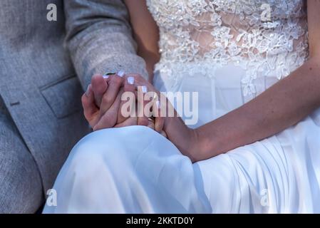Bride and groom holding hands during the wedding ceremony, Nidersacsen Germany Stock Photo