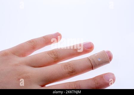 Finger in white bandage on a white background Stock Photo