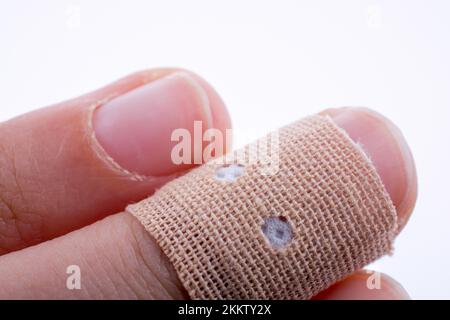 Finger in white bandage on a white background Stock Photo