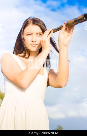 Attractive And Cute Visionary Woman With Spy Telescope Or Monocular Looking Out To Sea The Distant Horizon In Image Of Vision Visualization And Appari Stock Photo