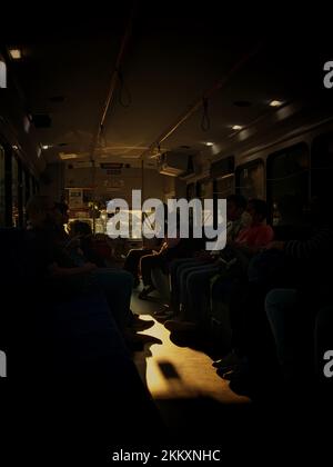 Inside bus is light of sun. People in transport. Details of interior of ...