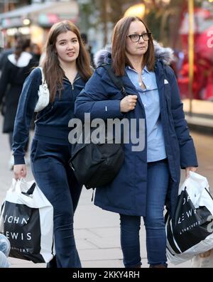 London, UK. 25th Nov, 2022. Shoppers walk in Oxford Street during Black Friday sales in London, UK, Nov. 25, 2022. Credit: Li Ying/Xinhua/Alamy Live News Stock Photo