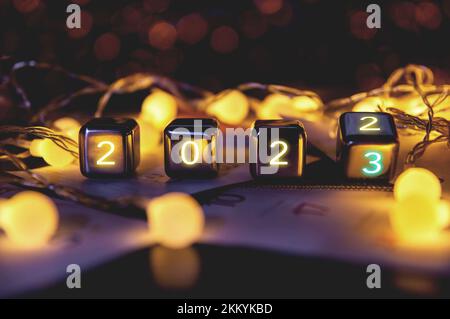 2023,happy new year 2023 concept banner, flip calendar numbers 2022 to 2023 on steel cube blocks isolated on bokeh lights background. Stock Photo