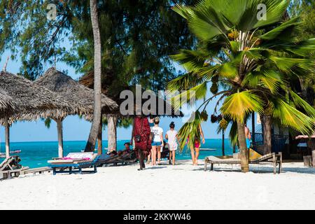 Zanzibar, Tanzania - January 02,2022: Maasai warrior dressed in traditional clothes on sand beach of Zanzibar island. Stock Photo