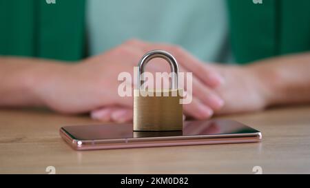 Closed metal padlock on smartphone, personal data security Stock Photo