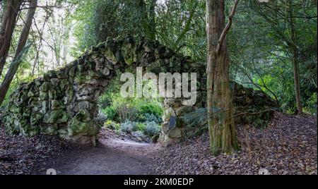 close up of a stone archway built over a pathway in Stourhead estate, Wilts UK Stock Photo