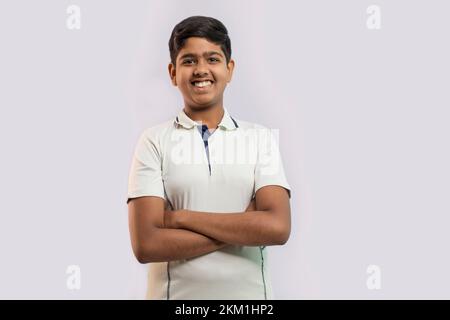 A boy in cricket uniform smiling and standing Stock Photo