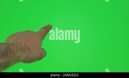 Male hand gestures on green screen: pointing or tapping on the screen, chromakey. 4k Stock Photo