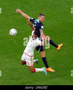 Australia's Mitchell Duke (right) and Tunisia's Ali Abdi battle for the ball during the FIFA World Cup Group D match at the Al Janoub Stadium in Al-Wakrah, Qatar. Picture date: Saturday November 26, 2022. Stock Photo