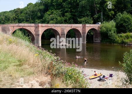 Bridge over the River Wye with people enjoying the hottest day on record, Bredwardine, Herefordshire Stock Photo