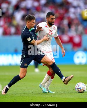 Tunisia's Ali Abdi (right) and Australia's Ajdin Hrustic battle for the ball during the FIFA World Cup Group D match at the Al Janoub Stadium in Al-Wakrah, Qatar. Picture date: Saturday November 26, 2022. Stock Photo