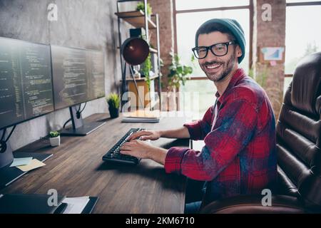 Photo of smiling cheerful coder dressed hat glasses creating good ...