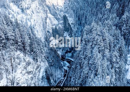 Carpathian, Romania, 2021-12-28. Road crossing two snow-covered mountainsides. Stock Photo