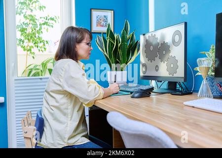 Middle aged female graphic designer working from home Stock Photo