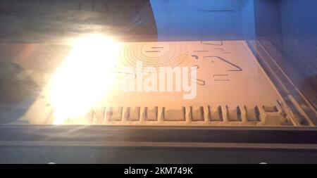 3D printer printing process. High-speed printing of an object on a 3D printer from powder close-up. Creation of a three-dimensional volumetric model on a 3D printer. MJF printing additive technology. Stock Photo