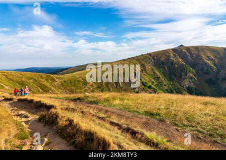 Vosges (Vogesen) Mountains: summit Hohneck, view to South to mountain basin Wormspelkessel, hiker in Alsace (Elsass), Haut-Rhin (Oberelsass), France Stock Photo