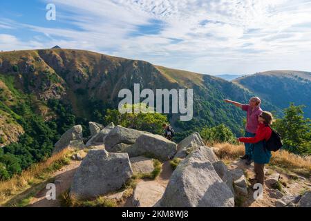 Vosges (Vogesen) Mountains: summit Hohneck, view to South to mountain basin Wormspelkessel, hiker in Alsace (Elsass), Haut-Rhin (Oberelsass), France Stock Photo