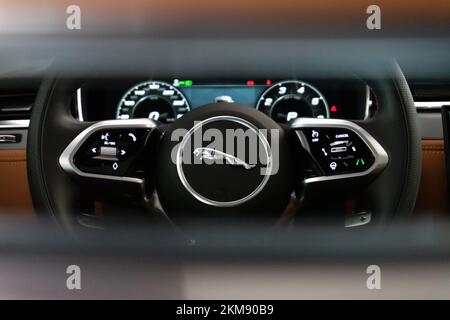 A closeup of the Jaguar F-Pace steering wheel behind driver's seat Stock Photo