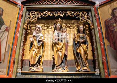 The carved winged altar with Virgin Mary, Saint Rose, Saint Barbara, Germany 16th century Stock Photo