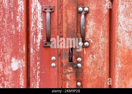 Weathered barn doors to a metal building Stock Photo