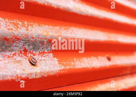A sceew in the side of a metal building. Stock Photo