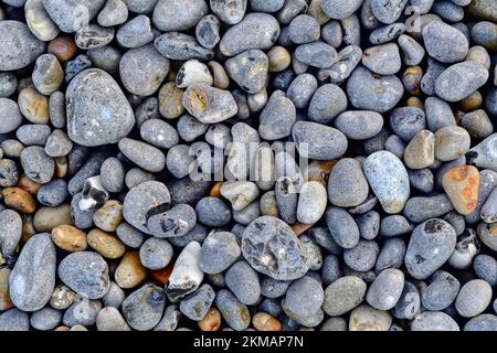 Grey pebbles on a beach for a background or design element Stock Photo