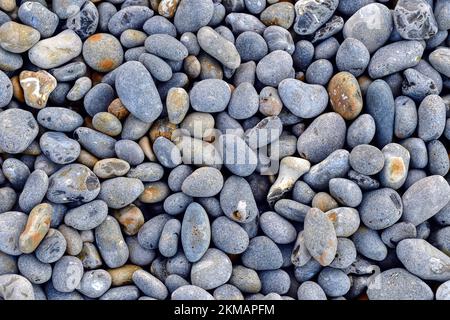 Grey pebbles on a beach for a background or design element Stock Photo