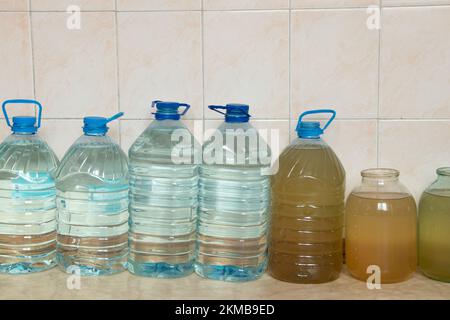 Plastic bottles with water on the floor of a house in Ukraine, bottles filled with water due to a power outage during rocket attacks in Ukraine, witho Stock Photo