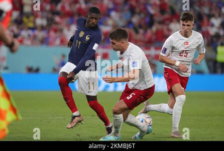 France's Ousmane Dembele and Danish Joakim Maehle fight for the ball during a soccer game between France and Denmark, in Group D of the FIFA 2022 World Cup, at the Stadium 974, in Doha, State of Qatar on Saturday 26 November 2022. BELGA PHOTO VIRGINIE LEFOUR Stock Photo