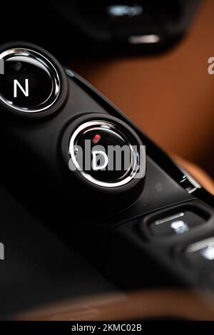 A vertical closeup of an Aston Martin Vantage drive mode selector buttons Stock Photo