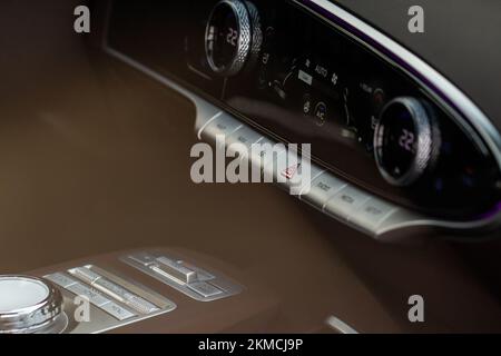 Red triangle hazard light button on car dashboard. Car media buttons dashboard. Detail of a modern car controllers. Stock Photo