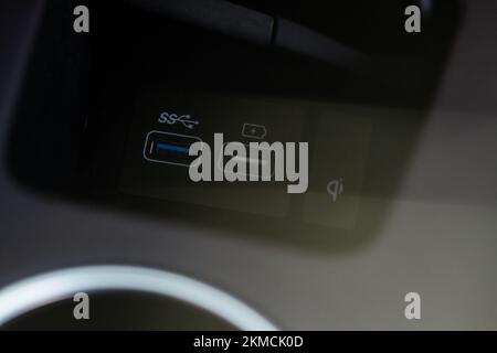 Opened car USB port in the car for connecting device. Power output of usb charger close up view. Car interior. Stock Photo
