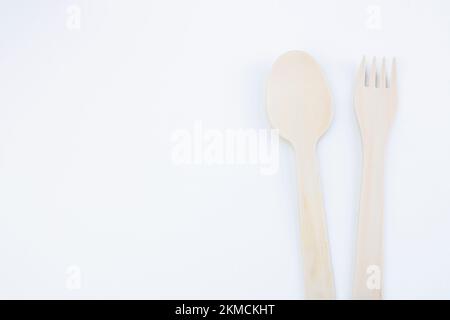 eco friendly disposable kitchen utensils on a white background. wooden fork, spoon. Ecology, zero waste concept. View from above. Flat lay. Stock Photo