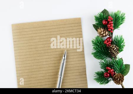 Notebook sheet in a ruler with pen and Christmas branch isolated on white background. Christmas mail. Congratulations concept for Christmas or New Yea Stock Photo