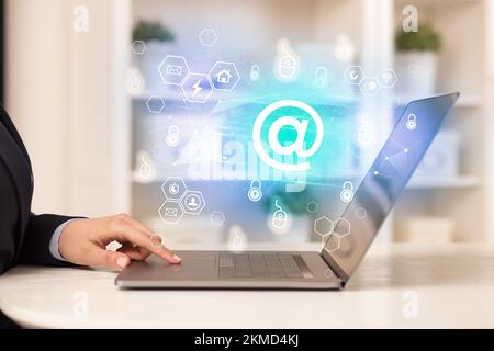 Hands working on laptop with digital icons concept Stock Photo