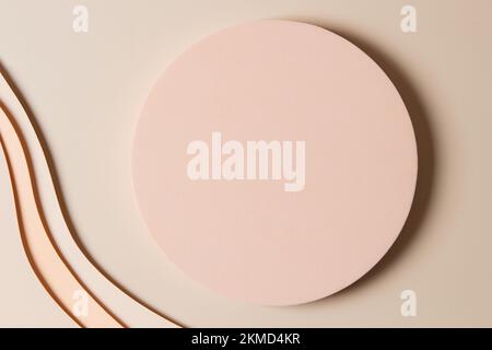Blank round geometric shape podium platform on paper cut abstract minimal geometric shape light brown background. Top view mock up for product display Stock Photo