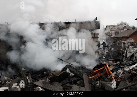 DNIPRO, UKRAINE - NOVEMBER 26, 2022 - Smoke rises from a burnt-out house after a Russian rocket attack on Dnipro, central Ukraine. As reported, six people have been injured and seven private houses partially destroyed. Stock Photo