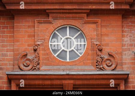 Decorative relief and circular window on a doorway, London England United Kingdom UK Stock Photo