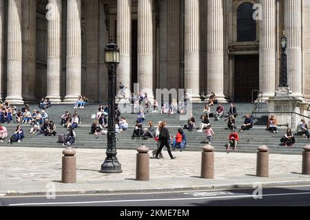 People enjoying sunny day in front of St Paul's Cathedral in London, England United Kingdom UK Stock Photo