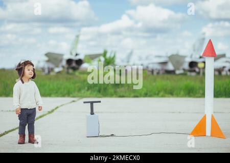 Adorable baby launching a rocket on the aerodrome Stock Photo