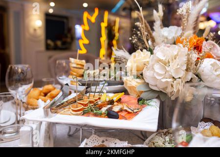 caviar canapes and fish slices on a plate on the buffet table Stock Photo